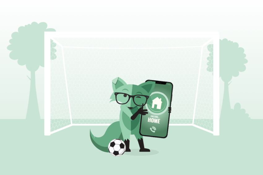 Image of Mint Fox holding a large smartphone with an home icon and text reading Home on the screen in front of a soccer goal with a soccer ball at his feet.